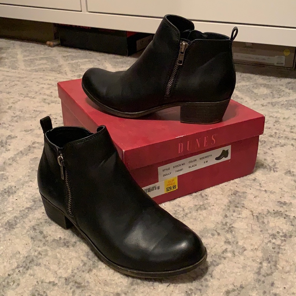 Black Dunes Dolly boots with zipper accents.